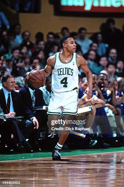 David Wesley of the Boston Celtics moves the ball up-court against the Los Angeles Lakers during a game played in 1995 at the Boston Garden in...