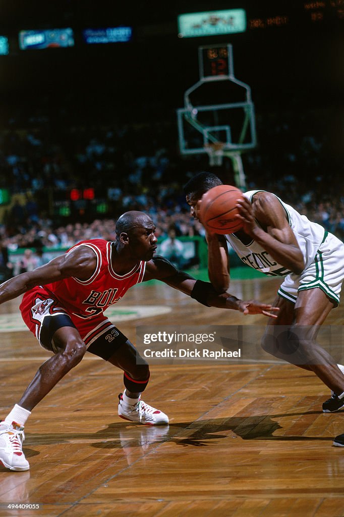 Reggie Lewis Reggie Lewis of the Boston Celtics handles the ball against Michael ...