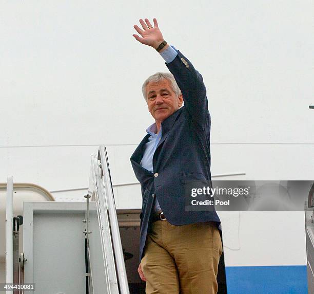 Defense Secretary Chuck Hagel waves as he boards his plane during his departure on May 29, 2014 at Joint Base Elmendorf-Richardson, Alaska. Hagel is...