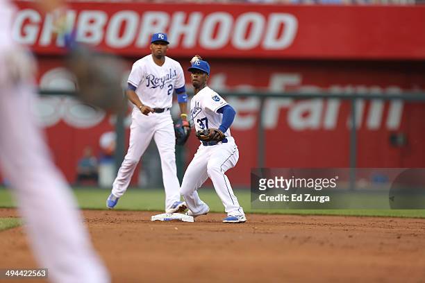 Pedro Ciriaco of the Kansas City Royals throws to first for the out against the Chicago White Sox at Kauffman Stadium on May 21, 2014 in Kansas City,...