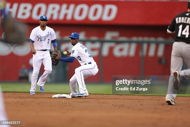 Pedro Ciriaco of the Kansas City Royals throws to first for the out against the Chicago White Sox at Kauffman Stadium on May 21, 2014 in Kansas City,...