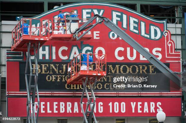 Workers paint the Wrigley Field Marquee on May 14, 2014 in Chicago, Illinois. The Chicago Cubs and Benjamin Moore are kicking off an exclusive...