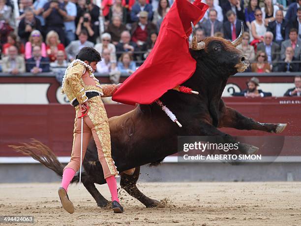 Spanish matador Alejandro Talavante performs a pass on a bull during the San Isidro Feria bullfight at the Las Ventas bullring in Madrid on May 29,...