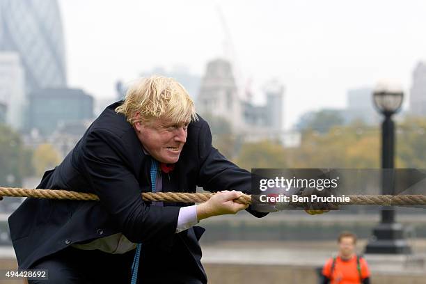 Mayor of London, Boris Johnson competes in a tug of war during the launch of London Poppy Day on October 27, 2015 in London, England. Poppies have...