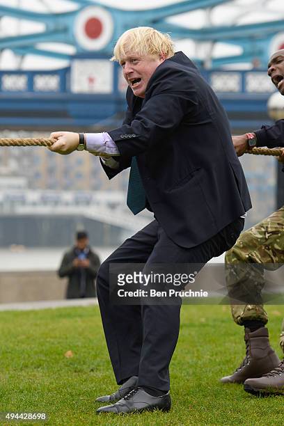 Mayor of London, Boris Johnson competes in a tug of war during the launch of London Poppy Day on October 27, 2015 in London, England. Poppies have...