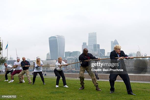 Mayor of London, Boris Johnson competes in a tug of war during the launch of London Poppy Day on October 27, 2015 in London, England. Poppies have...