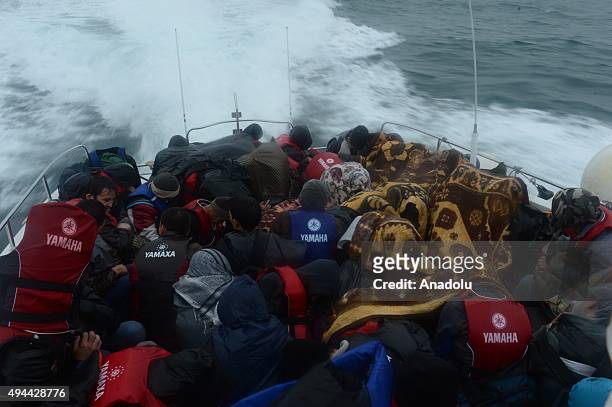 Refugees are seen on a boat after they rescued by Turkish coast guards while they were illegally trying to reach Greece's Lesbos island through the...