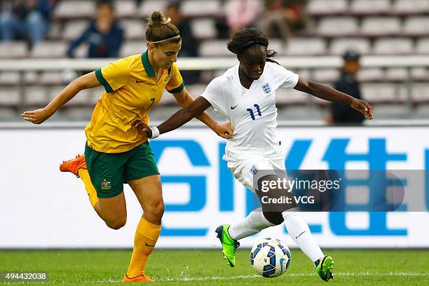 Eniola Aluko of England and Stephanie Catley of Australia compete for the ball in the match between England and Australia during the 2015 Yongchuan...