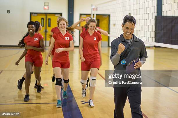 girls volleyball players with coach after big win - high school volleyball 個照片及圖片檔