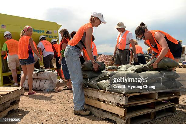 Kelly Hall of Windsor, front left, and her daughter Emily are filling sand bags at the Ranch in Budweiser Events Center. Loveland, Colorado. May 29....