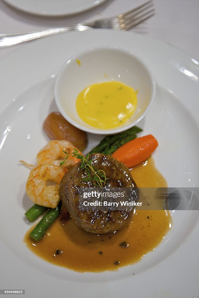 Beef, shrimp and vegetables with sauce on plate