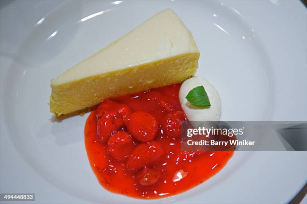 slice of cheesecake with strawberry sauce - strawberry syrup stock pictures, royalty-free photos & images