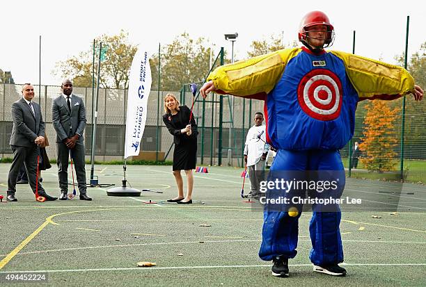 Minister of Sport, Tracey Crouch, aims at a target man as she takes part in Snag Golf as the Sport England Director of Community Sport, Mike Diaper...