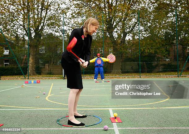 The Minister of Sport, Tracey Crouch, aims at a target man as she takes part in Snag Golf as she visits the Sports Pavillion at The Hyde to Unveil...