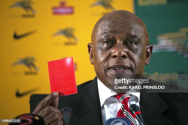 South African businessman and International Federation of the Football Association candidate to the presidency Tokyo Sexwale, holds a red card as he...