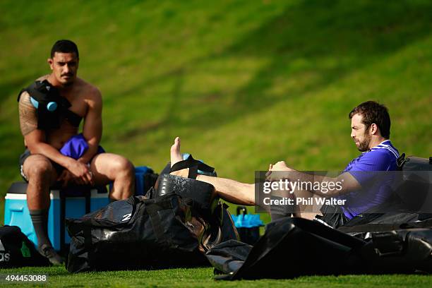 Conrad Smith recovers following training with Jerome Kaino (L during a New Zealand All Blacks training session at Pennyhill Park on October 27, 2015...