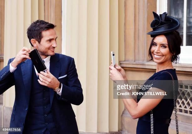 New York City FC's English midfielder and retired England international footballer, Frank Lampard, poses for his partner Christine Bleakley holding...