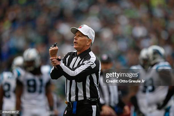 Referee Terry McAulay of the Seattle Seahawks signals a holding penalty against the Seattle Seahawks during the game against the Carolina Panthers at...