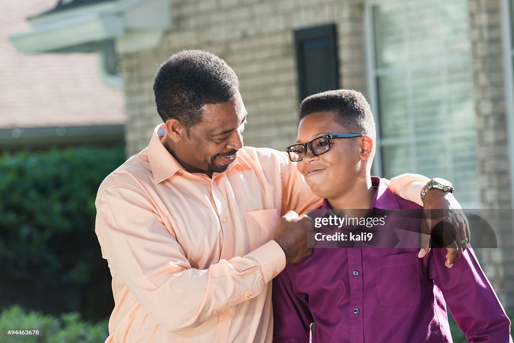 Proud African American father with teenage son