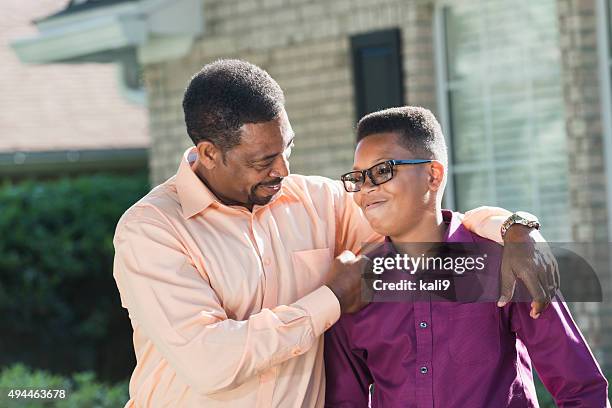 proud african american father with teenage son - proud father stock pictures, royalty-free photos & images