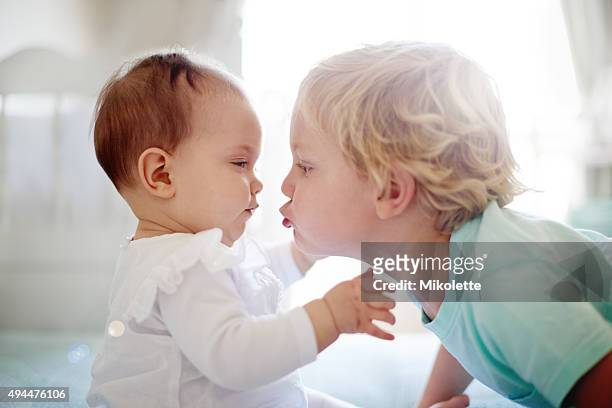 they're already the closest of friends - siblings baby stock pictures, royalty-free photos & images