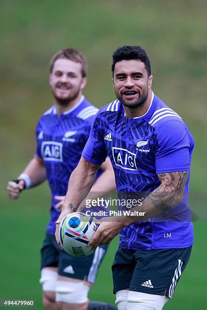 Liam Messam of the All Blacks passes during a New Zealand All Blacks training session at Pennyhill Park on October 27, 2015 in Bagshot, United...