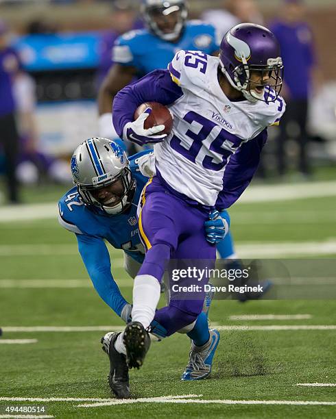 Marcus Sherels of the Minnesota Vikings runs past the diving Isa Abdul-Quddus of the Detroit Lions during an NFL game at Ford Field on October 25,...
