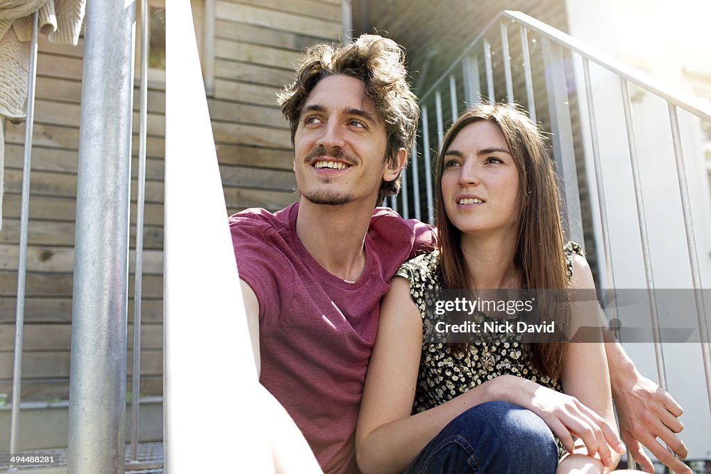 Couple sitting outside together
