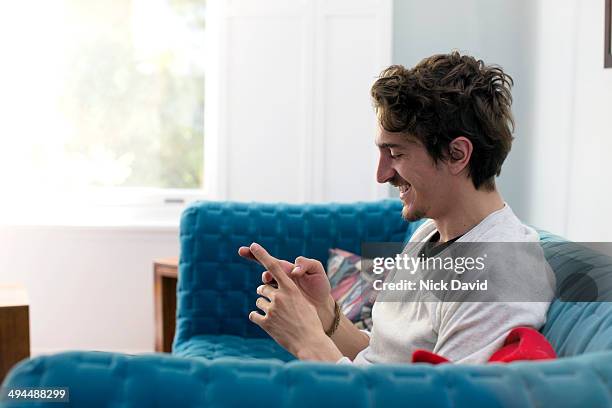 man using mobile phone - mann handy couch stock-fotos und bilder