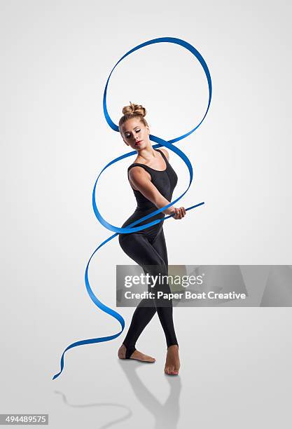 gymnast waving blue ribbon around her body - the human body ストックフォトと画像