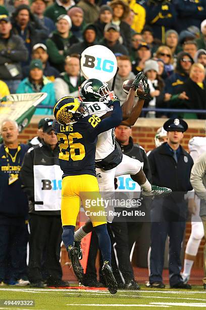 Aaron Burbridge of the Michigan State Spartans attempts to make a catch in the fourth quarter against Jourdan Lewis of the Michigan Wolverines at...