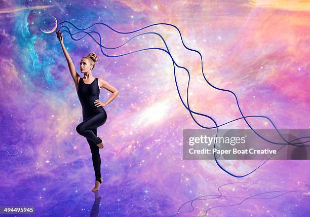 gymnast against cosmic sky, waving blue ribbons - pilates abstract stock pictures, royalty-free photos & images