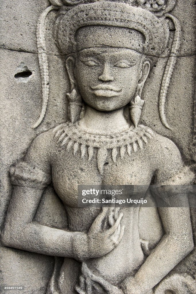 Stone sculpture of a female devata  on Angkor Wat