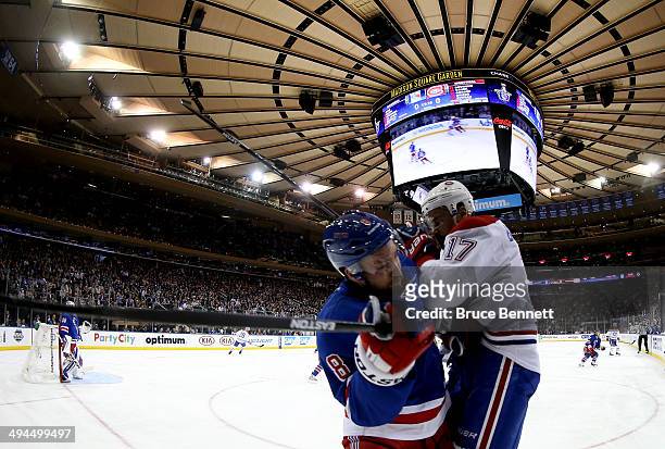 Rene Bourque of the Montreal Canadiens and Kevin Klein of the New York Rangers collide along the boards during Game Six of the Eastern Conference...
