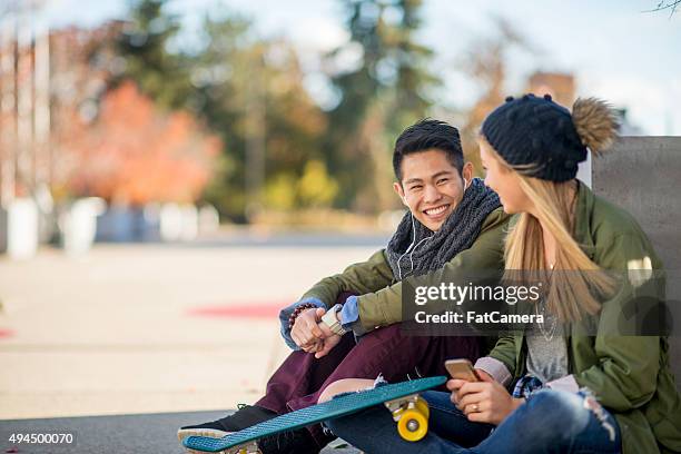 couple sitting together outside - girl flirting stock pictures, royalty-free photos & images