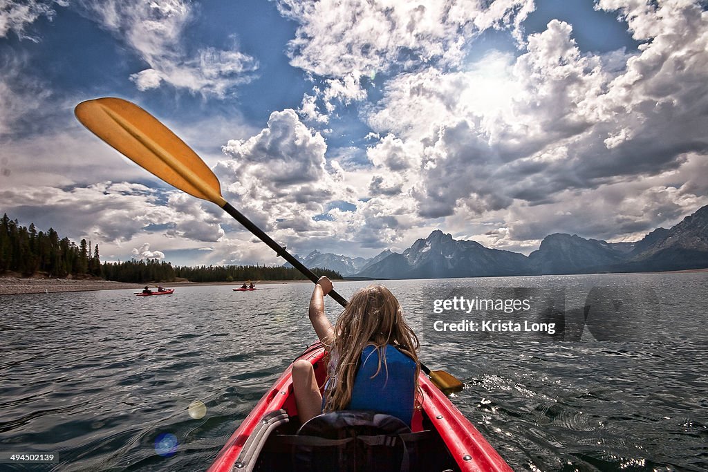 A girl kayaking on a summer day