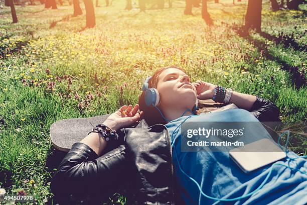 teenage girl lying down in the grass - girls sunbathing stock pictures, royalty-free photos & images
