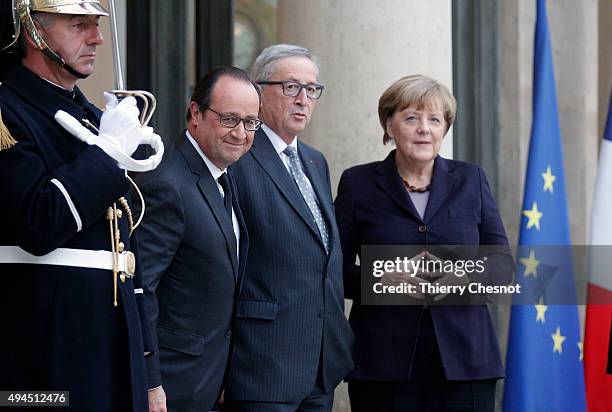 French President Francois Hollande German Federal Chancellor Angela Merkel and European Commission President Jean-Claude Juncker pose prior to a...