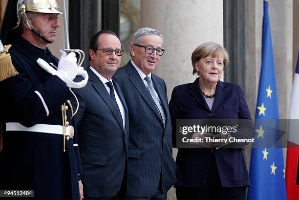 French President Francois Hollande German Federal Chancellor Angela Merkel and European Commission President Jean-Claude Juncker pose prior to a...