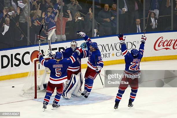 Henrik Lundqvist of the New York Rangers celebrates with his teammates after defeating the Montreal Canadiens in Game Six of the Eastern Conference...