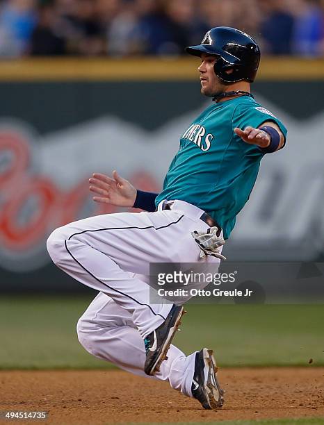Cole Gillespie of the Seattle Mariners slides into third against the Houston Astros at Safeco Field on May 23, 2014 in Seattle, Washington.
