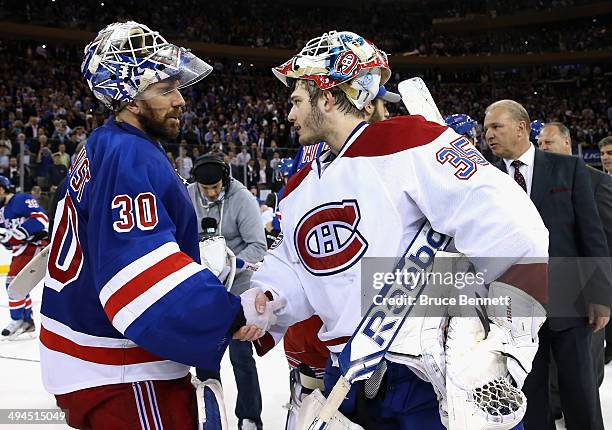 Henrik Lundqvist of the New York Rangers ashakes hands with Dustin Tokarski of the Montreal Canadiens after winning Game Six to advance to the...