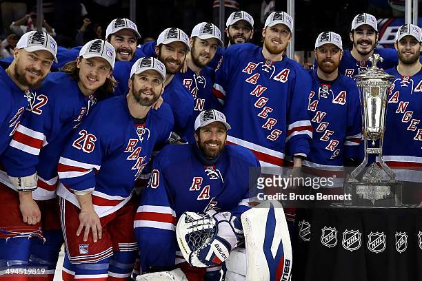 Henrik Lundqvist of the New York Rangers and the rest of the team pose with the Prince of Wales Trophy after defeating the Montreal Canadiens in Game...