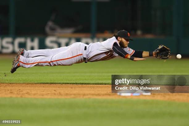 Brandon Crawford of the San Francisco Giants dives for a ground ball against the St. Louis Cardinals in the ninth inning at Busch Stadium on May 29,...