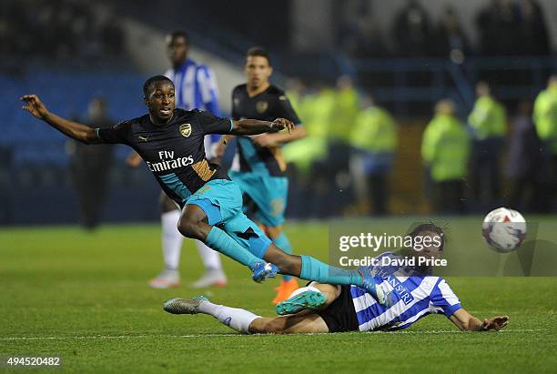 Glen Kamara of Arsenal is tackled by Sam Hutchinson of Sheffield Wednesday during the Capital One Cup 4th Round match between Sheffield Wednesday and...