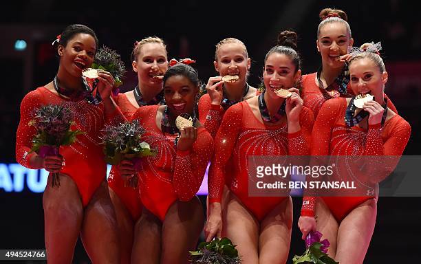 The USA women's team celebrate with their gold medal's after winning the Women's Team event final on the fifth day of the 2015 World Gymnastics...