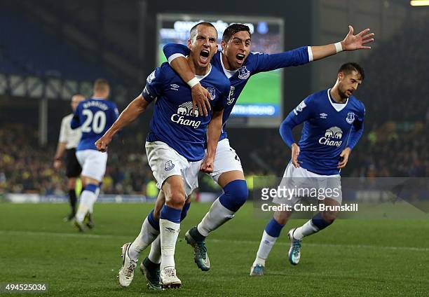 Leon Osman of Everton celebrates scoring his side's first goal with team-mate Ramiro Funes Mori during the Capital One Cup Fourth Round match between...