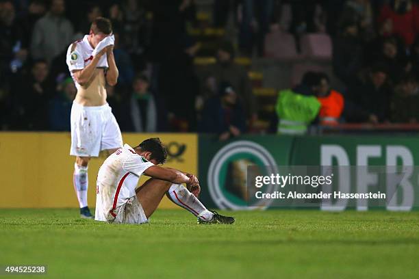 Rani Khedira of Leipzig reacts with his team mate Marcel Halstenberg after the DFB Cup round two match between SpVgg Unterhaching and RB Leipzig at...