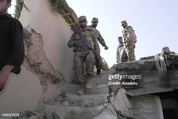 Pakistani soldiers conduct search and rescue operation following a massive earthquake in Lower Dir district of the northwestern Khyber Pakhtunkhwa...