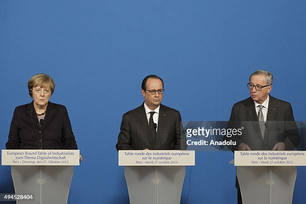 German Chancellor Angela Merkel, French President Francois Hollande and European Commission President Jean-Claude Juncker attend a joint statement...
